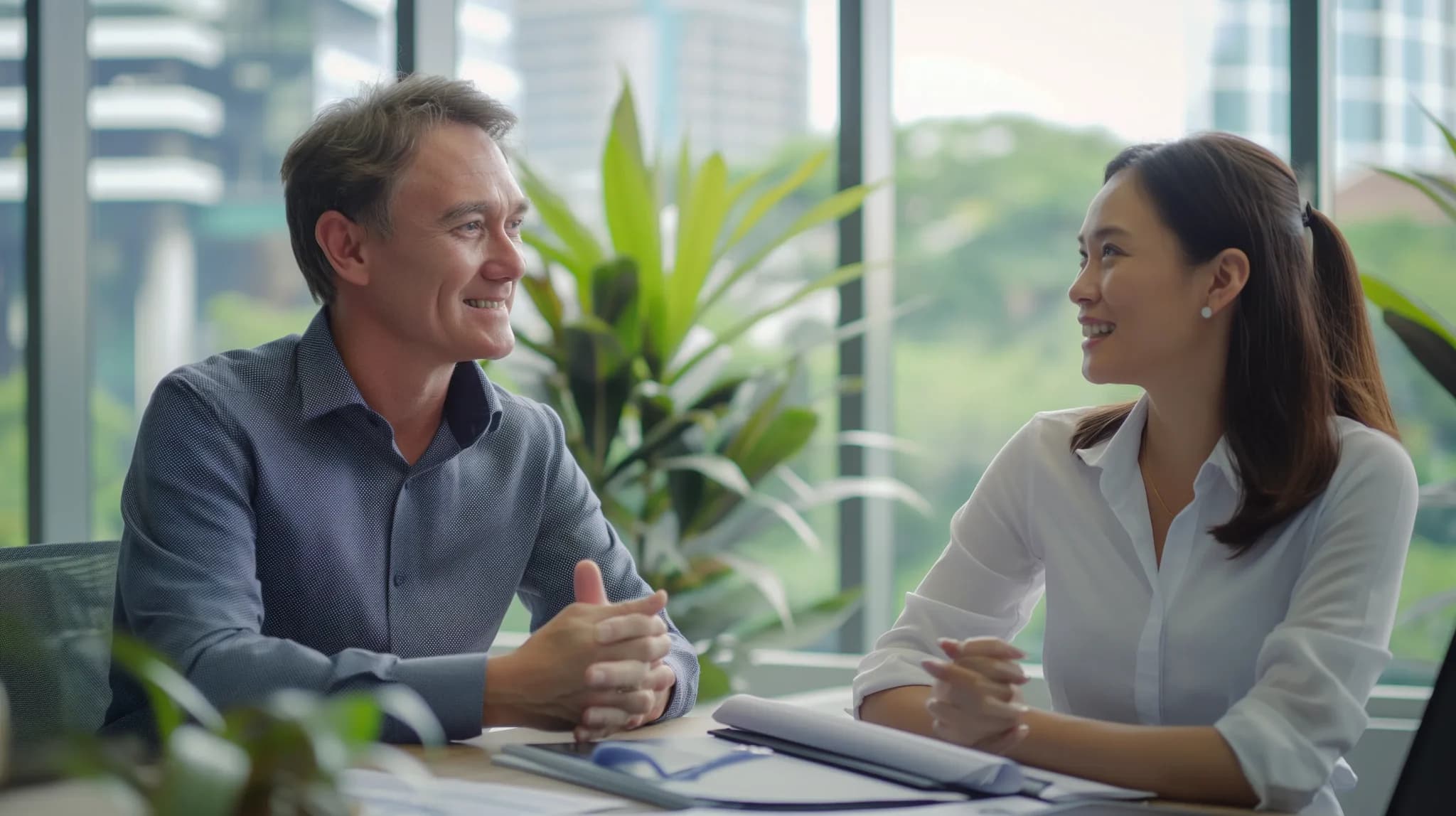 A foreign investor in Malaysia talking to a Malaysian business consultant regarding double tax agreement